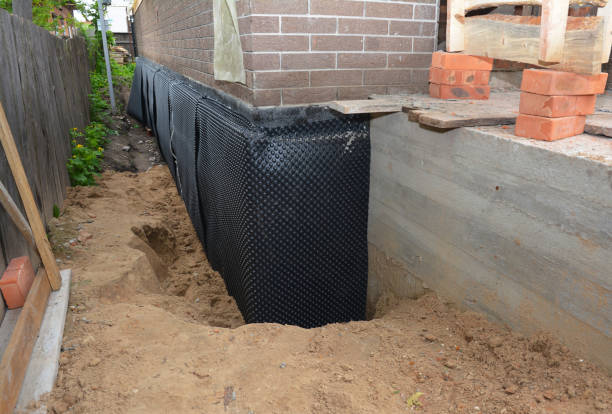 Happy homeowners after waterproofing job in Goshen